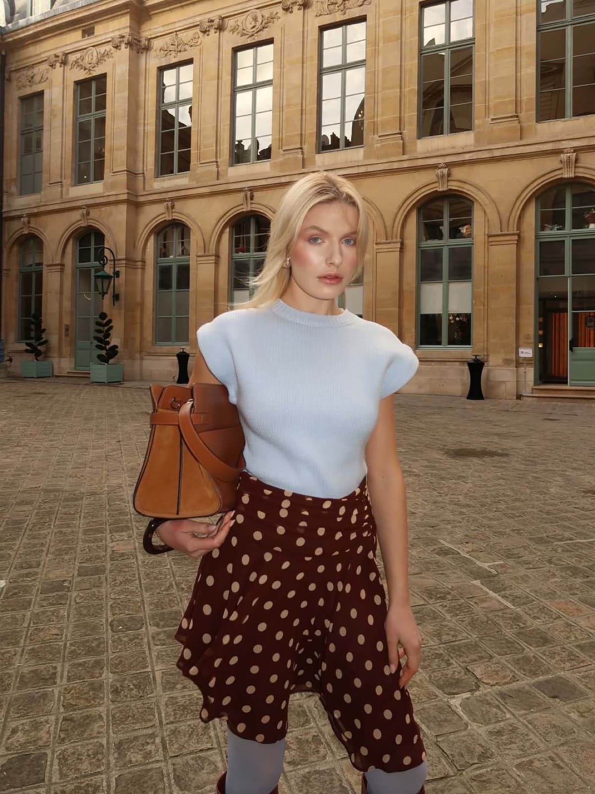 Woman in a Parisian courtyard during a fashion photo session by SabShots